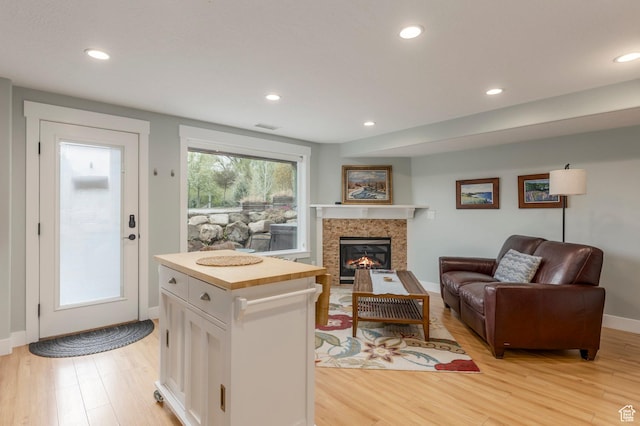 1920 S Wall St, Heber City, UT 84032 - living room with light wood finished floors, a tile fireplace, recessed lighting, and baseboards