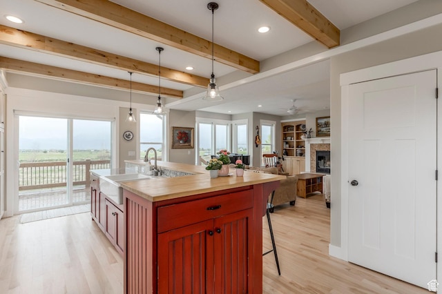 1920 S Wall St, Heber City, UT 84032 - kitchen featuring a sink, beamed ceiling, light wood finished floors, a breakfast bar, and wood counters