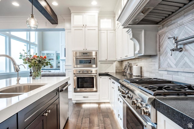 5314 W Rolling Brook Dr, Herriman, UT 84096 - kitchen featuring appliances with stainless steel finishes, a sink, extractor fan, white cabinets, and hanging light fixtures