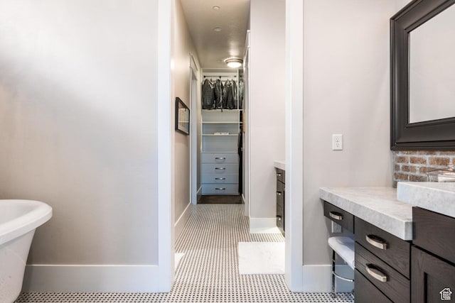 5314 W Rolling Brook Dr, Herriman, UT 84096 - bathroom featuring vanity, baseboards, and a spacious closet