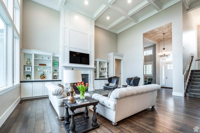 5314 W Rolling Brook Dr, Herriman, UT 84096 - living room with a towering ceiling, stairway, dark wood-type flooring, a fireplace, and a chandelier