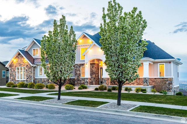 5314 W Rolling Brook Dr, Herriman, UT 84096 - craftsman-style home with stone siding, a front yard, a standing seam roof, metal roof, and board and batten siding