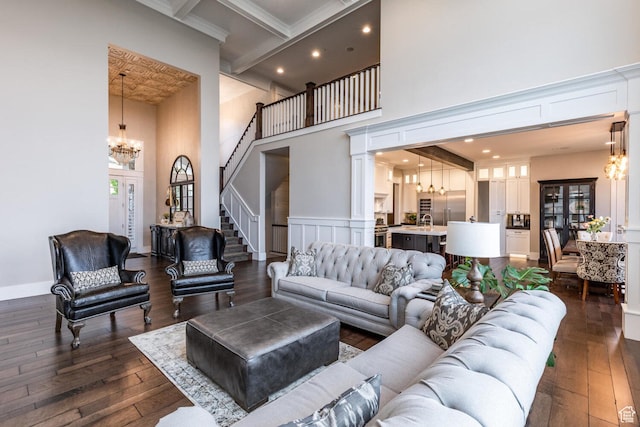5314 W Rolling Brook Dr, Herriman, UT 84096 - living area with a chandelier, a towering ceiling, dark wood-style flooring, stairway, and recessed lighting