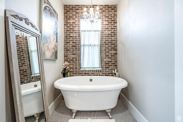 5314 W Rolling Brook Dr, Herriman, UT 84096 - bathroom with a chandelier, a freestanding tub, and baseboards