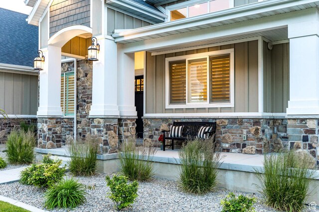 5314 W Rolling Brook Dr, Herriman, UT 84096 - view of exterior entry featuring stone siding, a porch, and board and batten siding