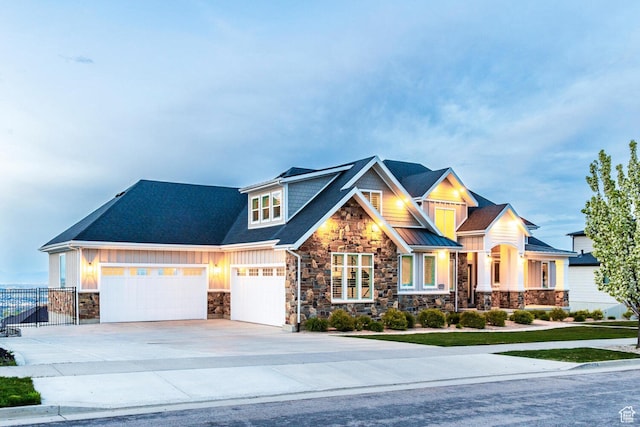 5314 W Rolling Brook Dr, Herriman, UT 84096 - craftsman house with stone siding, driveway, fence, board and batten siding, and a garage
