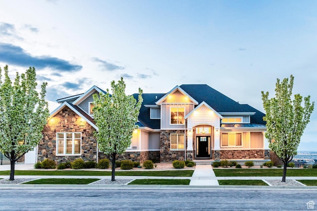 5314 W Rolling Brook Dr, Herriman, UT 84096 - view of front of home with stone siding, a front yard, a standing seam roof, and metal roof