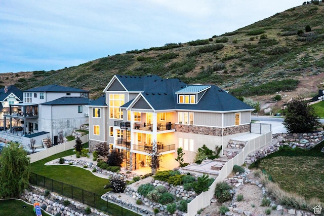 5314 W Rolling Brook Dr, Herriman, UT 84096 - back of property featuring stone siding, stairs, a mountain view, and a balcony