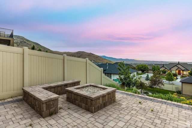 5314 W Rolling Brook Dr, Herriman, UT 84096 - view of patio / terrace featuring a fire pit, a fenced backyard, and a mountain view
