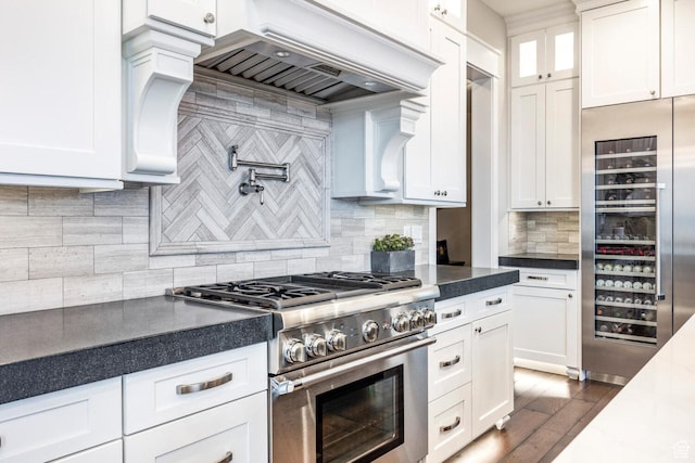 5314 W Rolling Brook Dr, Herriman, UT 84096 - kitchen featuring high end stove, custom range hood, white cabinetry, wine cooler, and dark countertops