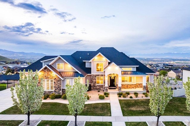5314 W Rolling Brook Dr, Herriman, UT 84096 - view of front of home with a standing seam roof, stone siding, metal roof, driveway, and board and batten siding