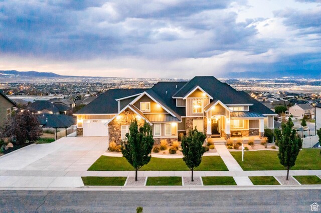 5314 W Rolling Brook Dr, Herriman, UT 84096 - craftsman-style home with stone siding, concrete driveway, a standing seam roof, an attached garage, and a yard