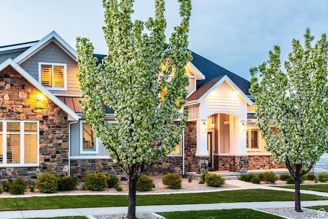 5314 W Rolling Brook Dr, Herriman, UT 84096 - craftsman-style house with stone siding, a front yard, and a standing seam roof