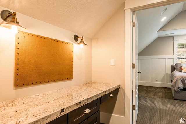 5314 W Rolling Brook Dr, Herriman, UT 84096 - bathroom featuring lofted ceiling, a decorative wall, and a wainscoted wall