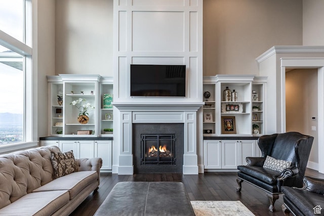 5314 W Rolling Brook Dr, Herriman, UT 84096 - living area featuring a fireplace with flush hearth and dark wood-style floors