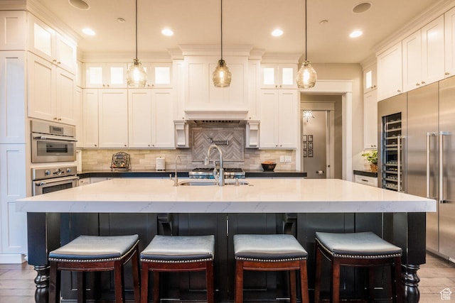 5314 W Rolling Brook Dr, Herriman, UT 84096 - kitchen with stainless steel built in fridge, a sink, decorative backsplash, white cabinetry, and a center island with sink