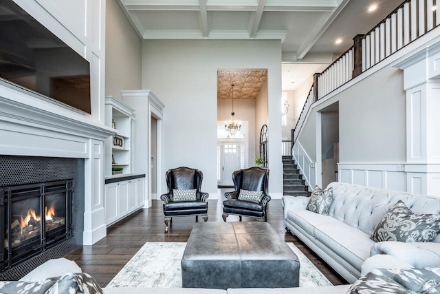 5314 W Rolling Brook Dr, Herriman, UT 84096 - living area with dark wood-type flooring, a chandelier, beam ceiling, a tiled fireplace, and a towering ceiling