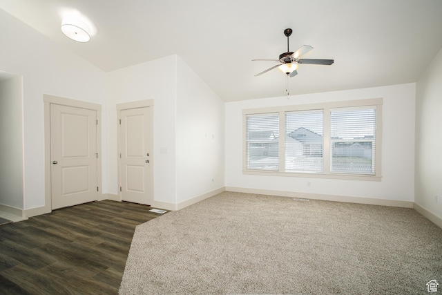 unfurnished room featuring ceiling fan, vaulted ceiling, baseboards, and dark wood-type flooring
