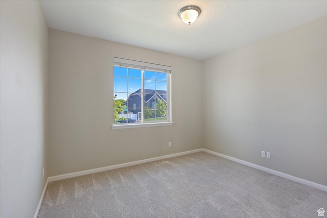 empty room with carpet flooring and baseboards