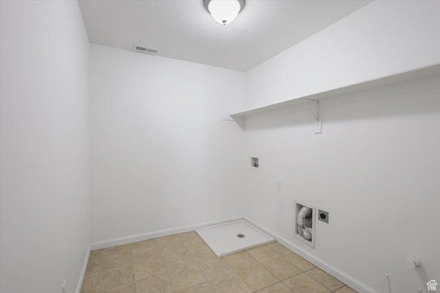 laundry area with hookup for a washing machine, gas dryer hookup, baseboards, hookup for an electric dryer, and a textured ceiling