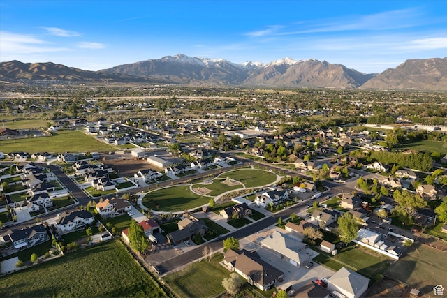 aerial view of property and surrounding area with a mountain backdrop and nearby suburban area