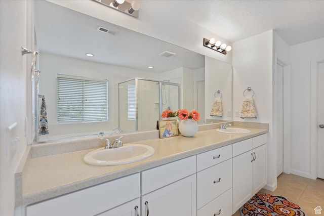 bathroom with a stall shower, tile patterned floors, double vanity, and recessed lighting