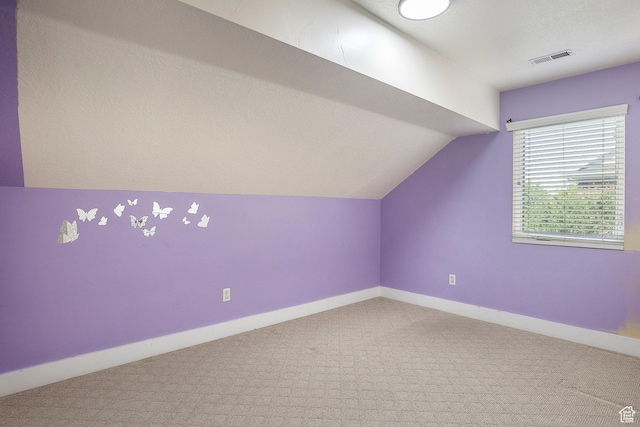 additional living space with lofted ceiling, carpet floors, and baseboards