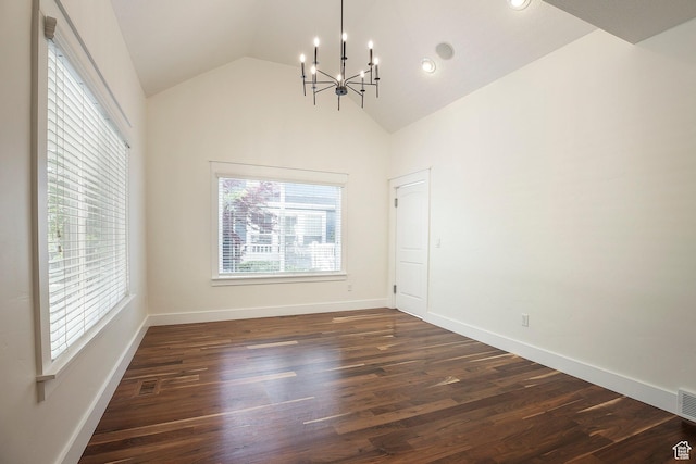 unfurnished dining area featuring a chandelier, lofted ceiling, dark wood-type flooring, and baseboards