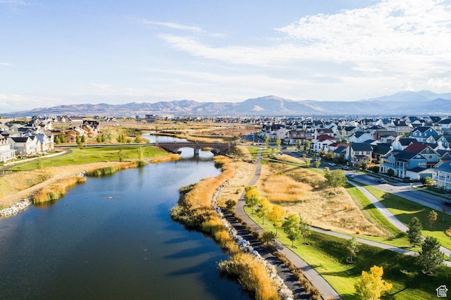aerial view of residential area featuring a water and mountain view