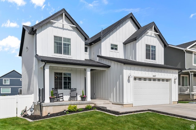2607 N Mclaws Ave, Layton, UT 84040 - view of front of home featuring covered porch, board and batten siding, a garage, and driveway