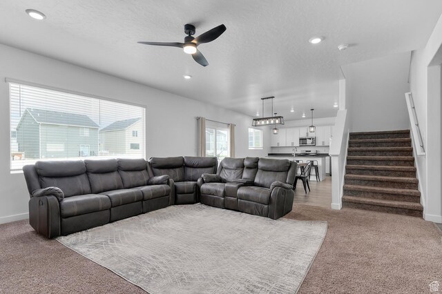 2607 N Mclaws Ave, Layton, UT 84040 - living area with light carpet, a ceiling fan, stairs, recessed lighting, and baseboards
