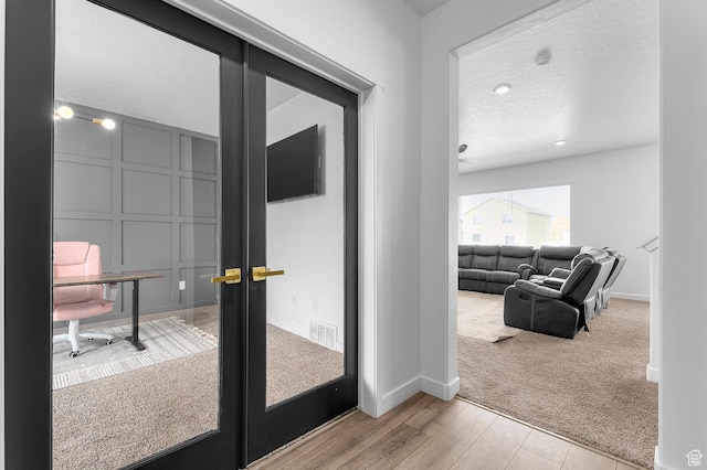 2607 N Mclaws Ave, Layton, UT 84040 - doorway with light wood-type flooring, baseboards, light colored carpet, and french doors