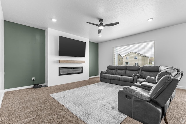 2607 N Mclaws Ave, Layton, UT 84040 - living area featuring carpet floors, a glass covered fireplace, ceiling fan, a textured ceiling, and recessed lighting
