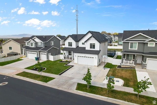 2607 N Mclaws Ave, Layton, UT 84040 - view of front of home with a residential view, a garage, concrete driveway, and a porch