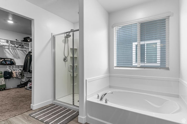 2607 N Mclaws Ave, Layton, UT 84040 - bathroom with a shower stall, wood finished floors, a walk in closet, and a bath