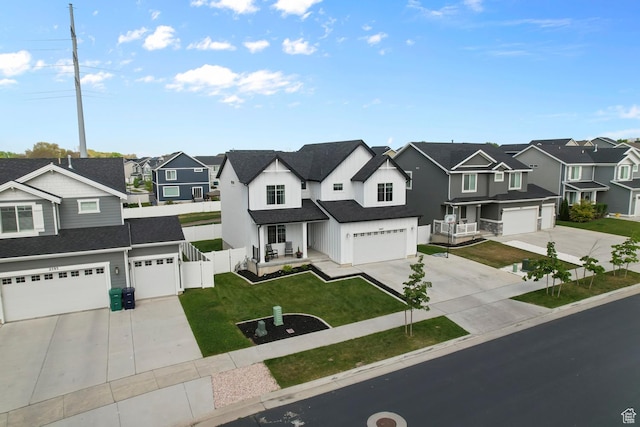 2607 N Mclaws Ave, Layton, UT 84040 - view of front of house with a residential view, driveway, an attached garage, board and batten siding, and covered porch