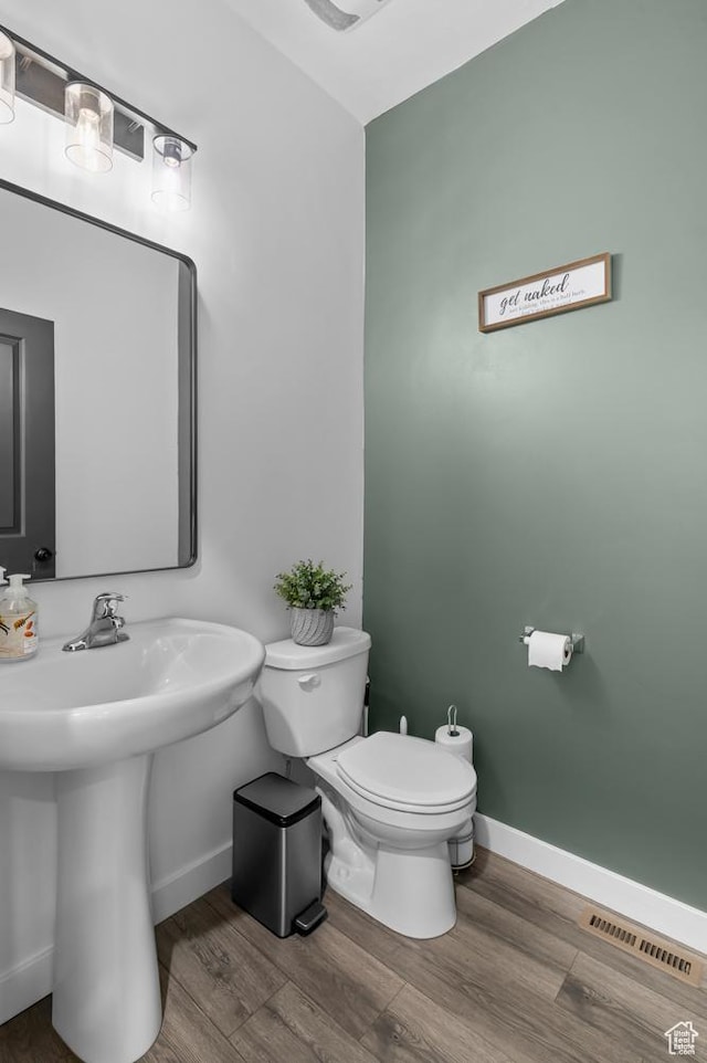 2607 N Mclaws Ave, Layton, UT 84040 - bathroom featuring baseboards, toilet, wood finished floors, and a sink