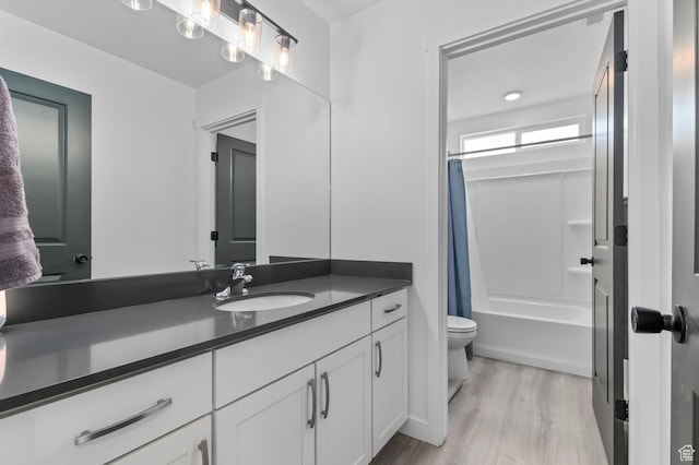 2607 N Mclaws Ave, Layton, UT 84040 - full bathroom featuring toilet, vanity, wood finished floors, and shower / bathtub combination with curtain