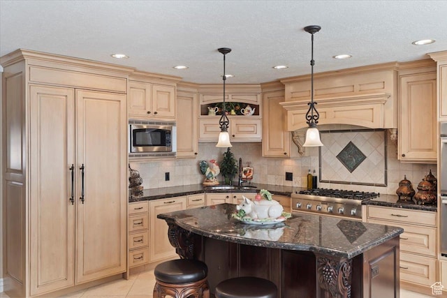 10543 S 2330 W, South Jordan, UT 84095 - kitchen featuring built in appliances, a kitchen breakfast bar, a center island, cream cabinets, and dark stone counters