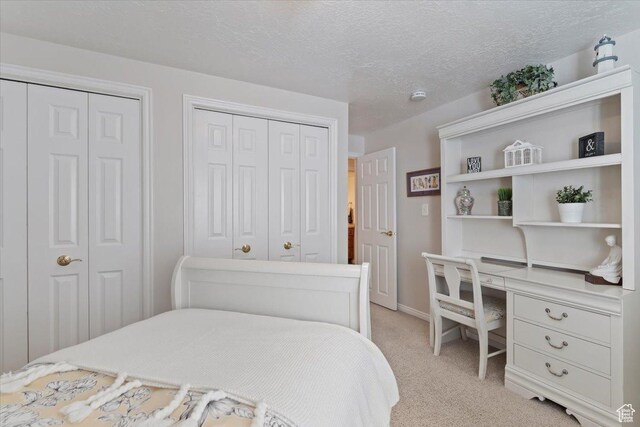 10543 S 2330 W, South Jordan, UT 84095 - bedroom with two closets, light colored carpet, a desk, a textured ceiling, and baseboards