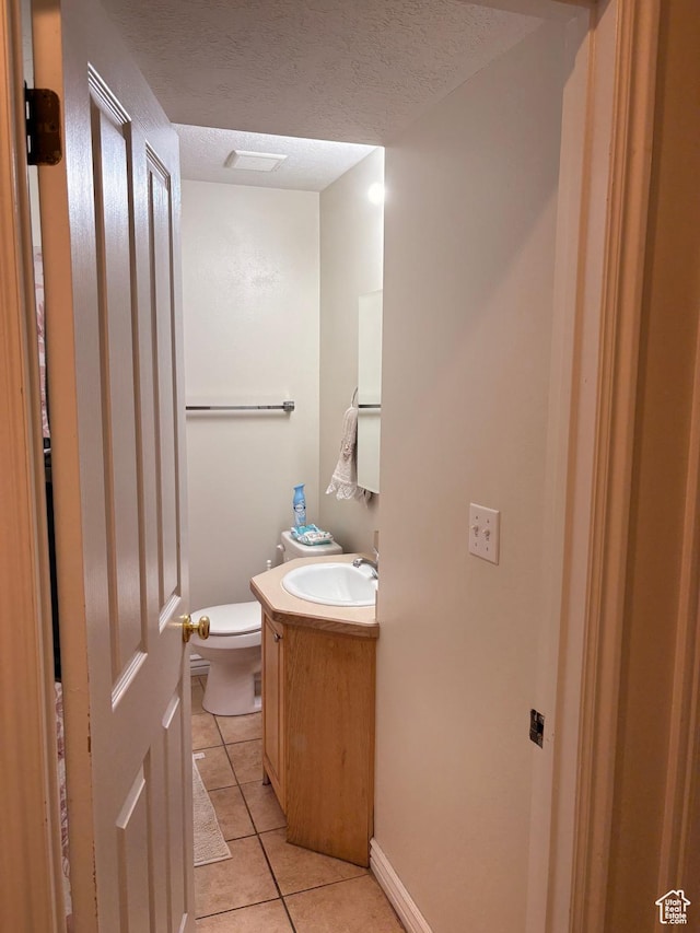 1559 N Riverside Ave Unit 9, Provo, UT 84604 - half bath with tile patterned floors, vanity, toilet, and a textured ceiling