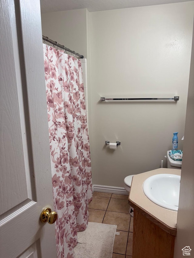 1559 N Riverside Ave Unit 9, Provo, UT 84604 - bathroom featuring tile patterned floors, vanity, toilet, a shower with curtain, and baseboards