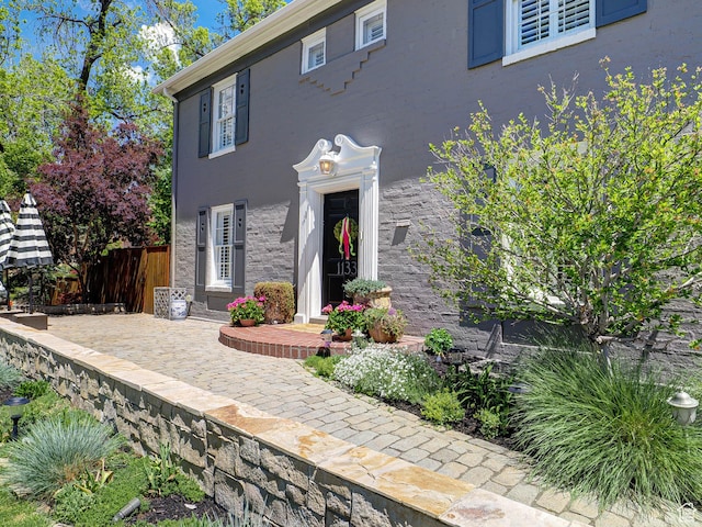 1133 S 1400 E, Salt Lake City, UT 84105 - view of front of house featuring fence, stone siding, and stucco siding