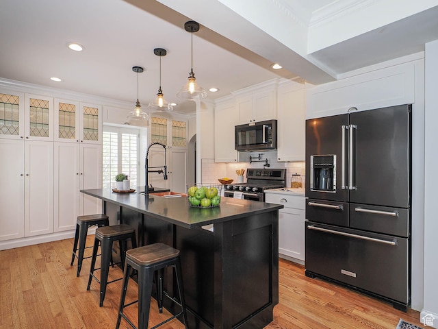 1133 S 1400 E, Salt Lake City, UT 84105 - kitchen with high end fridge, stainless steel range with gas cooktop, dark countertops, crown molding, and a sink