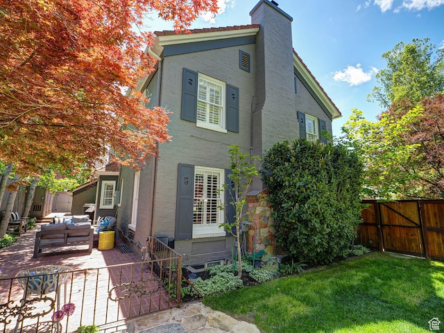 1133 S 1400 E, Salt Lake City, UT 84105 - back of property featuring an outdoor hangout area, a patio, a chimney, and stucco siding
