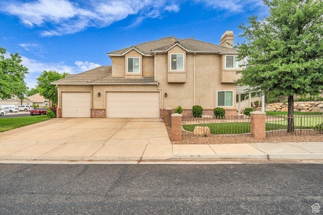1659 S Cobblestone Ln, St George, UT 84790 - traditional-style home featuring fence, a chimney, concrete driveway, stucco siding, and a tiled roof