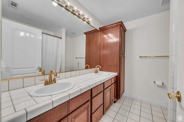 1659 S Cobblestone Ln, St George, UT 84790 - full bath featuring toilet, tile patterned flooring, baseboards, double vanity, and a textured ceiling