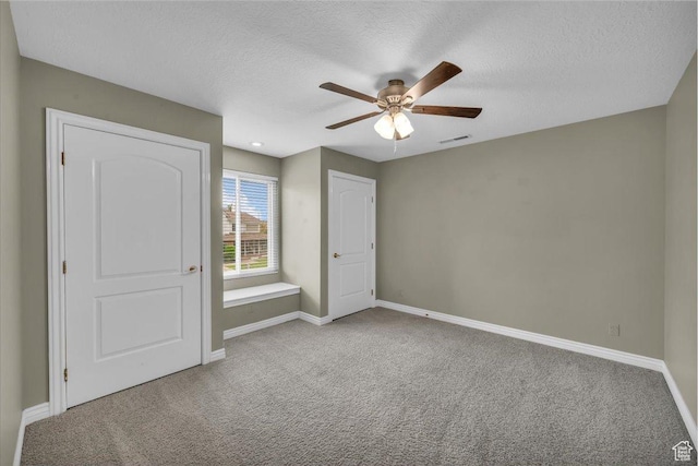 1659 S Cobblestone Ln, St George, UT 84790 - unfurnished bedroom with carpet flooring, baseboards, a textured ceiling, and ceiling fan