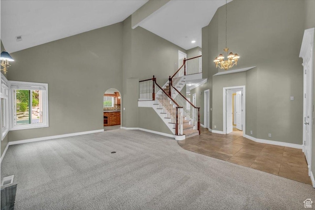 1659 S Cobblestone Ln, St George, UT 84790 - unfurnished living room with high vaulted ceiling, a chandelier, carpet floors, baseboards, and stairway