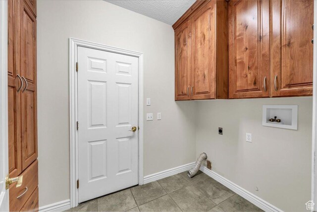1659 S Cobblestone Ln, St George, UT 84790 - laundry area featuring electric dryer hookup, washer hookup, cabinet space, baseboards, and a textured ceiling